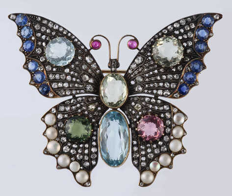 Брошь из желтого и белого металла, общим весом 24,0 грамма, содержит природные вставки